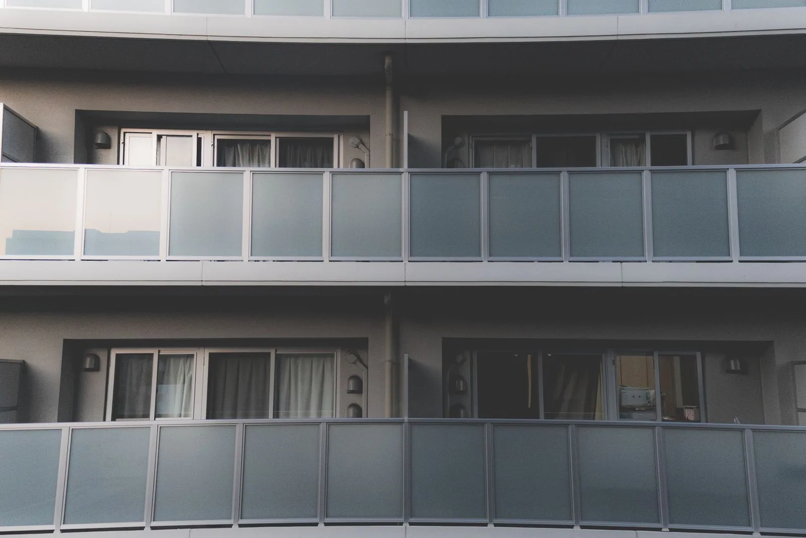 Contemporary apartment facade with glass balconies